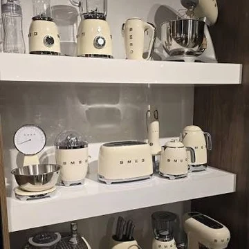 Customer photo &mdash; the collection arranged on open kitchen shelves